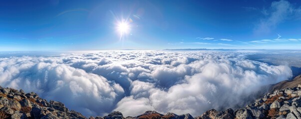 Wall Mural - a stunning aerial panorama of dense cumulus clouds bathed in sunlight, with a clear blue sky above.