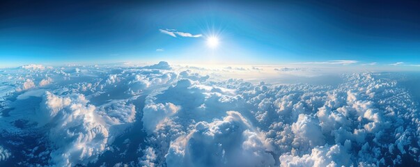 Wall Mural - a stunning aerial panorama of dense cumulus clouds bathed in sunlight, with a clear blue sky above.