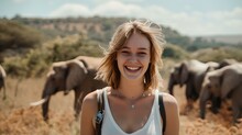 Joyful Young Woman Smiling With Elephants In The Backdrop. Casual Style, Travel Theme, Wildlife Encounter. Perfect For Adventure Blogs. AI