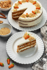 Wall Mural - Homemade carrot cake made with walnuts, iced with cream cheese. Sweet dessert.