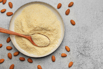 Canvas Print - Fresh almond flour in a  bowl and almonds