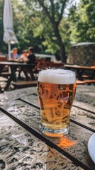 Poster - Pint of lager beer on outdoor patio table