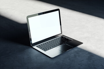 Poster - Open laptop on a concrete background with natural lighting, clean design technology mockup. 3D Rendering