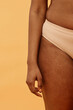 © AnnaStills - Conceptual studio shot of body part of unrecognizable Black woman in underwear, copy space