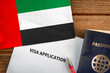 Visa application form, passport and flag of United Arab Emirates

