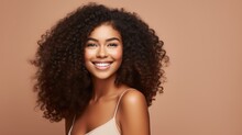 Portrait of a beautiful black woman with perfect fresh clean skin, curly hair, Snow-white smile on a beige background with a copy space. Makeup, Cosmetics, youth, skin care, Spa concepts.