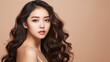 © liliyabatyrova - A beautiful Asian woman with perfect fresh clean skin, long hair on a beige background with a copy space. Makeup, Natural Beauty, Cosmetics, Cosmetology, Plastic Surgery, Youth, Facials, Spa concepts.