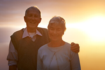 Canvas Print - Portrait, smile and senior couple at sunset for love, romance or retirement bonding outdoor together. Face, autumn or evening with happy elderly man and woman hugging for anniversary or commitment