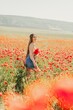 © svetograph - Woman poppies field. portrait happy woman with long hair in a poppy field and enjoying the beauty of nature in a warm summer day.