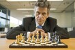 © studioworkstock - corporate strategist with a chessboard in an office