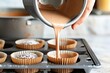 person pouring batter into a cupcake tray