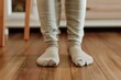 © studioworkstock - feet in bamboo fabric socks standing on a hardwood floor