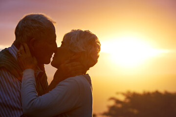 Canvas Print - Sunset, elderly couple or kiss outdoor, care or bonding together for connection in marriage. Man, woman or nose touch for love, romance or embrace for commitment to relationship in retirement on date