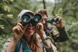 happy couple on vacation in mountains looking with binoculars