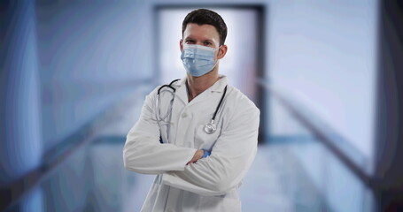 Sticker - Caucasian male doctor wearing face mask standing with arms crossed