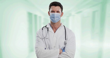 Poster - Portrait of caucasian male doctor wearing face mask against white background