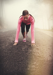 Canvas Print - Runner, start and woman on path outdoor in forest, park or woods for exercise in winter. Morning, fog and person with fitness challenge or prepare for workout on road in countryside with nature