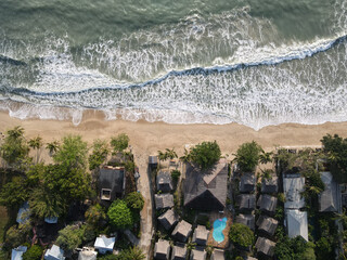 Wall Mural - waves on the shore with a city