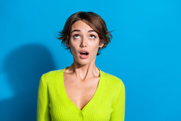 Poster - Portrait of impressed speechless girl open mouth look up empty space isolated on blue color background