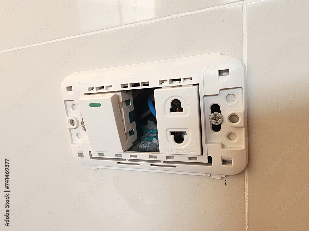 Installing light switch. On-off switch and mounted socket board with ...