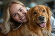 A joyful woman shares a beaming smile with her beloved golden retriever, radiating warmth and companionship in their cozy indoor setting