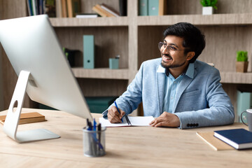 Aufkleber - Cheerful Indian Businessman Working at Desk Computer In Office