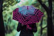 person holding umbrella with neon zebra pattern