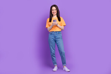 Wall Mural - Full body size photo of satisfied seller woman using smartphone to send financial agreement email isolated on purple color background