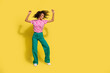 © deagreez - Full size portrait of overjoyed positive girl chilling dancing empty space isolated on yellow color background