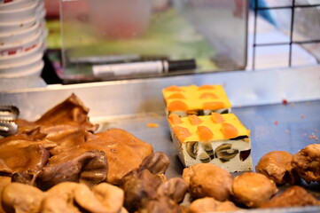 The food stall in the traditional market offers a range of prepared dishes, like braised meats and the popular Chinese dish 