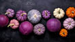 A group of pumpkins on a vivid purple color stone