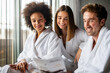 © NDABCREATIVITY - Group of happy people enjoying wellness relax weekend. Man with two beautiful women in bedroom.
