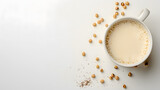 Fototapeta  - Cup of soybean milk on white background with copy space. Flat lay composition for design and print. Vegan beverage and healthy eating concept