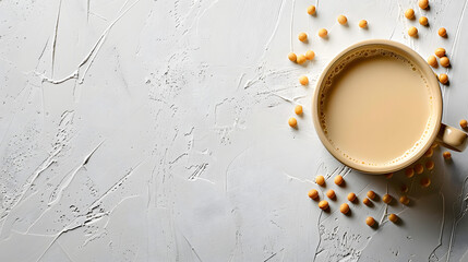 Wall Mural - Cup of soybean milk on white background with copy space. Flat lay composition for design and print. Vegan beverage and healthy eating concept