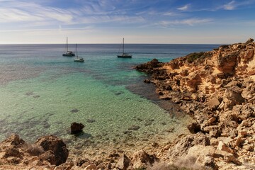 Poster - view of an idyllic cove at Es Cap Enderrocat in southern Mallorca with sailboats at anchor