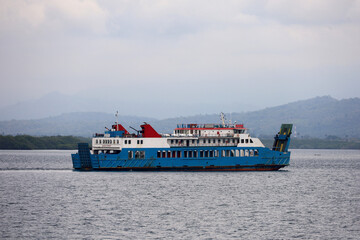 Ferries sail on the sea, ferries in the Bali Strait as a means of transportation between islands in Indonesia. inter-island logistics and economic crossing and shipping modes.