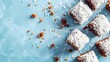 Easter lamingtons, coconut cakes on a blue background. Banner.
