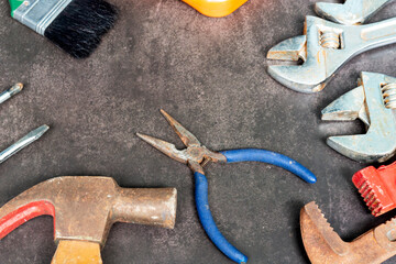 Old tools on concrete floor. Renovation, maintenance and repairing concept.