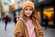 © Nerea - Outdoor fashion portrait of beautiful young woman wearing orange cap and coat