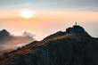 © EVERST - Man climber on the top of mountain travel in Norway outdoor sunset Lofoten islands landscape traveler silhouette on summit active healthy lifestyle adventure summer vacations extreme tour
