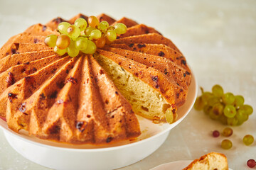 Poster - Delicious homemade grape sponge cake with noble mold cheese on a stone background.