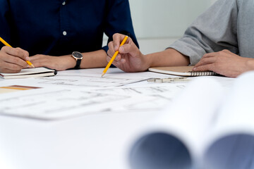 Wall Mural - Architect and engineer are discussing and viewing and editing plans