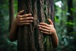 hands hugging the trunk of a tree