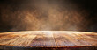 Warmly lit wooden table surface with intricate textures against a blurred, abstract backdrop. Ideal for backgrounds or displays. 