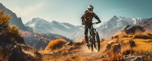 A Cyclist Navigating Through A Rugged Trail In Beautiful Mountain Landscape. Concept Cycling, Adventure, Mountains, Nature, Outdoors