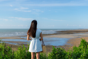 Poster - Back rear view of woman look at the sea beach