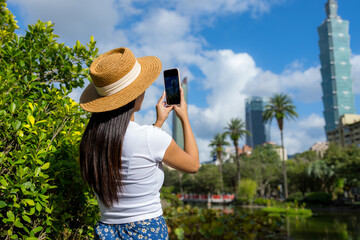 Poster - Woman use cellphone to take photo in Taipei city