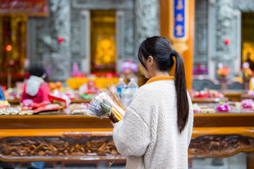 Asian woman pray in Chinese temple