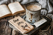 Cozy Father's Day setting, a cup of coffee and a book on a rustic table, with a note saying 