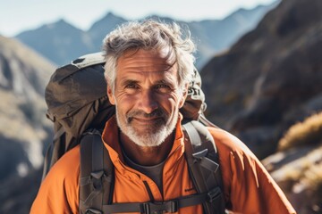 Wall Mural - Portrait of senior man hiking in the mountains. Hiking concept.